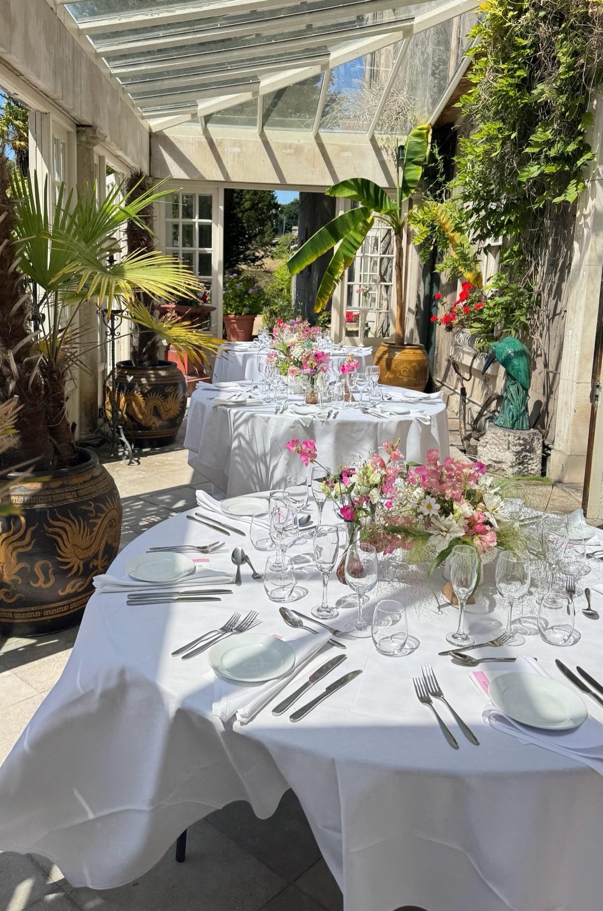 Wedding table setting in conservatory with flowers